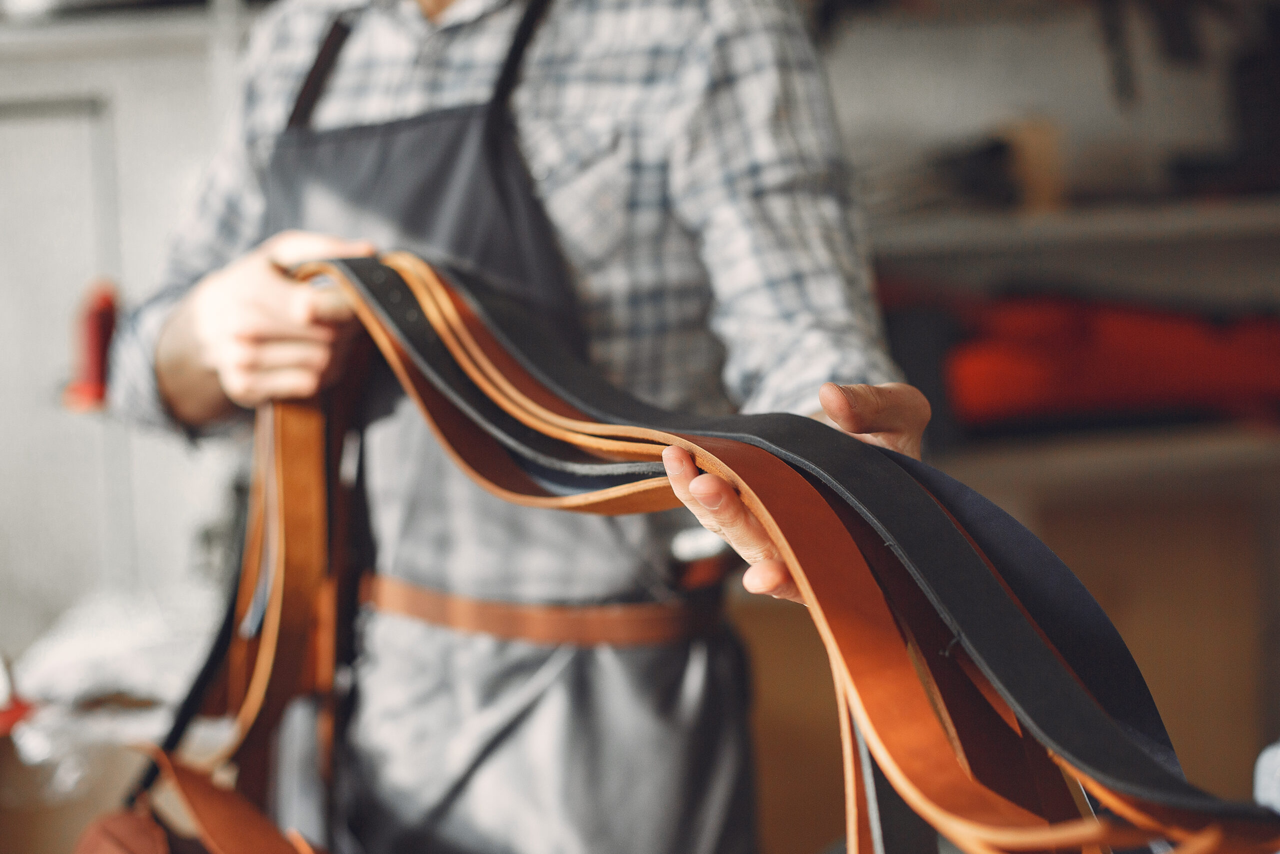 Home man in a studio creates leather ware
